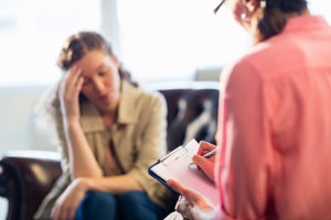 a woman talking to her doctor during Cognitive behavioral therapy