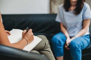 close up of therapist taking notes during woman's individual counseling program in Houston