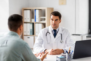 doctor consults with man at mens addiction treatment center