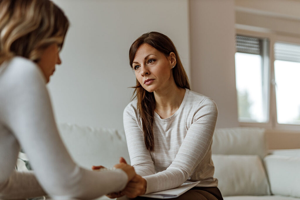 young woman discussing treatment for alcohol and depression with family member