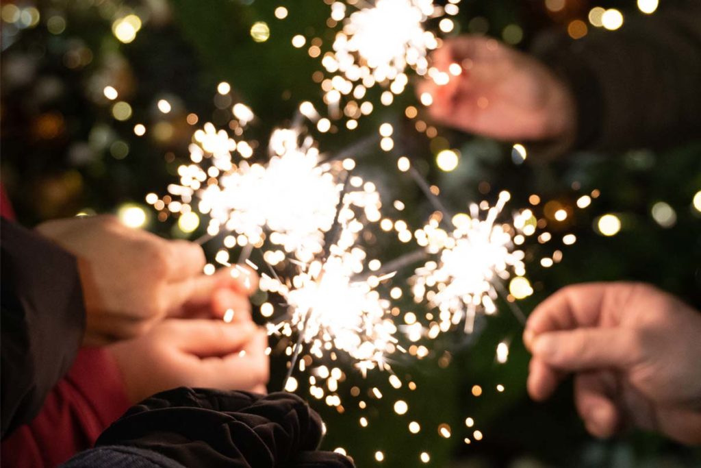 sober new years, hands holding sparklers in a circle