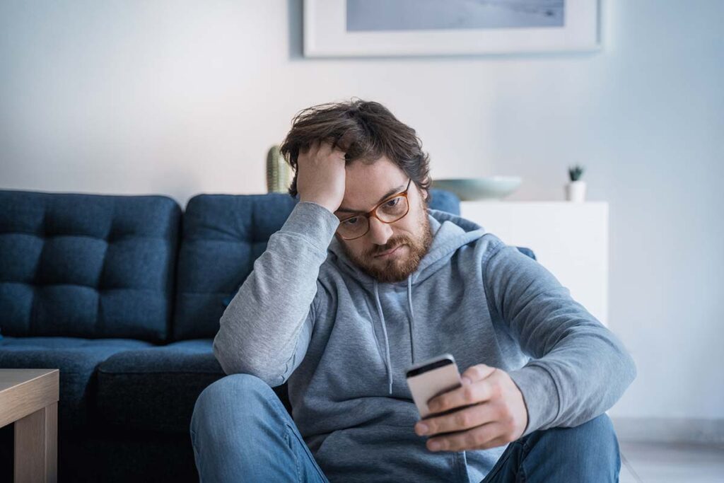 Man considering the link between drinking and social media