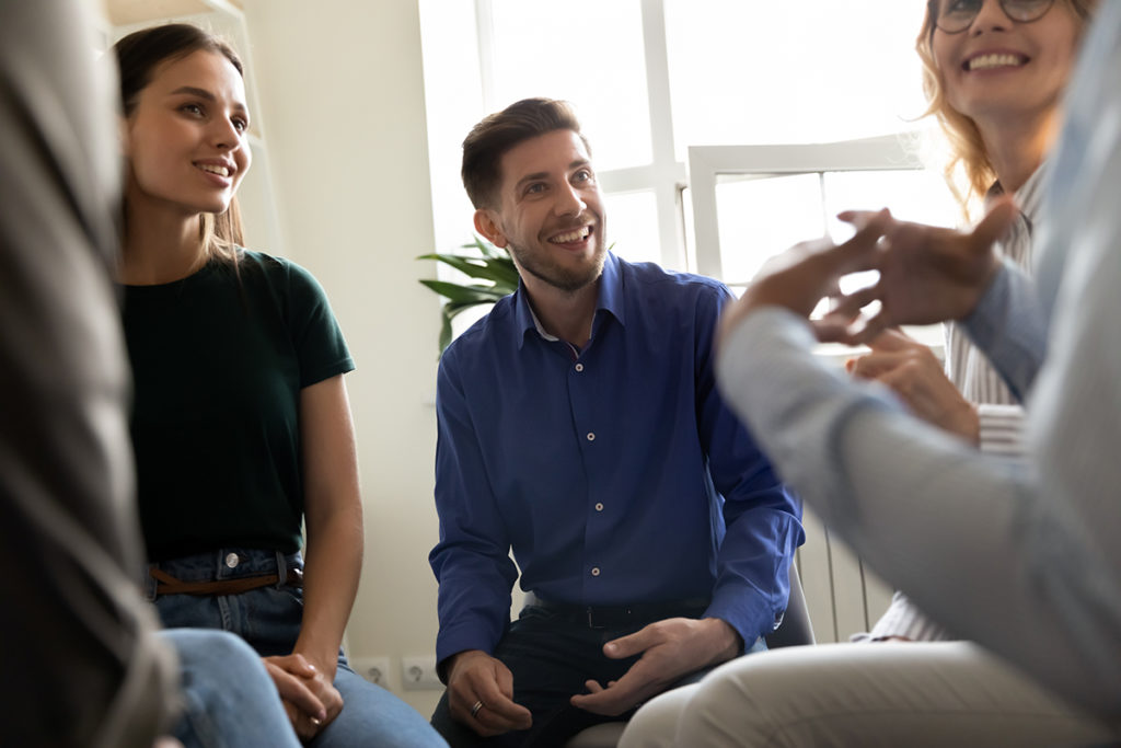 individuals in group therapy experiencing benefits of an alumni program