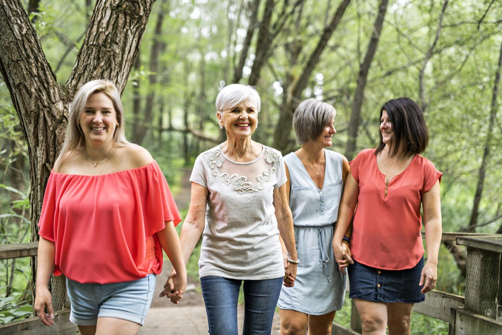 four women outside walking part of wine mom culture