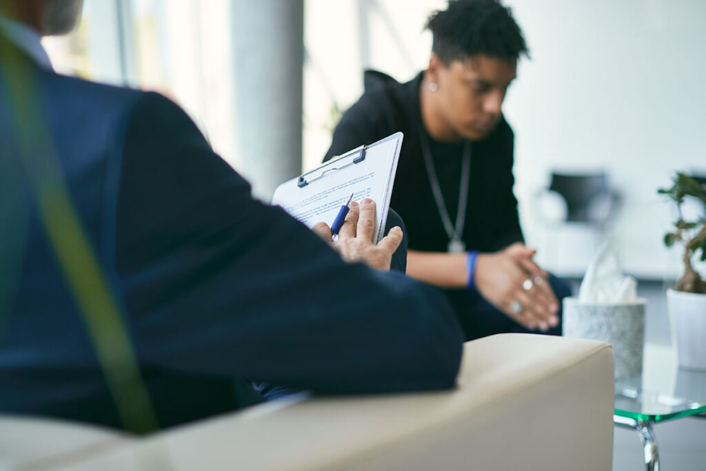 therapist in office setting explaining to client that cbt plays a large role in substance abuse treatment