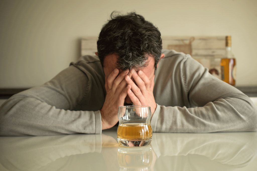 Person experiencing the side effects of GHB and alcohol abuse