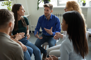 People sitting in a circle and talking at a prescription drug rehab program