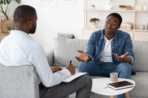 Person talking with their therapist at a trauma therapy program