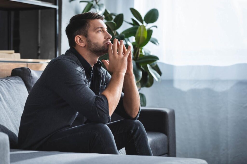 Person sitting and thinking about painkiller addiction