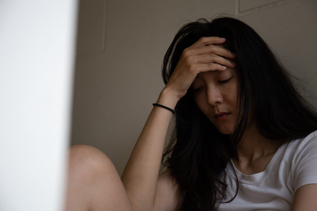Person feeling the long-term effects of alcohol abuse