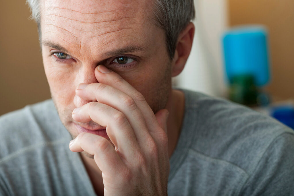 Man considering the effects of cocaine on the nose
